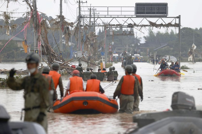 A car is pictured after it was drifted by torrential rain in Hitoyoshi