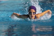 A young girl swimming in a pool