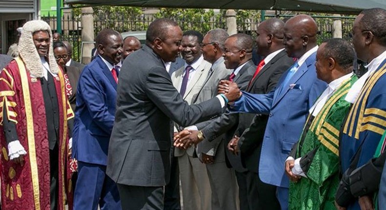 Gem MP Jakoyo Midiwo greeting President Uhuru Kenyatta. 