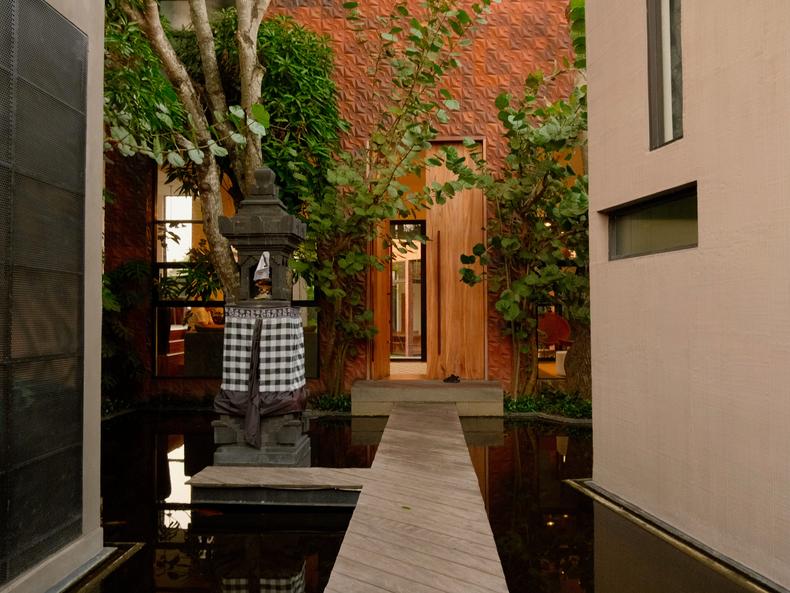 A narrow walkway, flanked by two koi ponds, leads from the gate to the main building's door.Amanda Goh/Business Insider