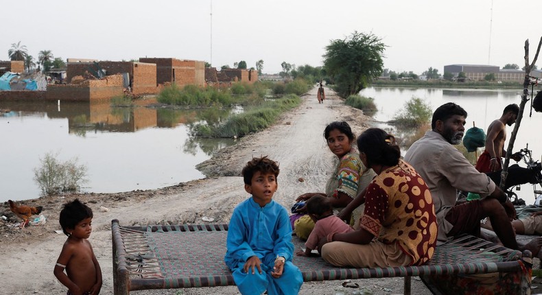 Flood victims in Mehar, Pakistan, sit along a street with submerged houses following monsoon rains in August.REUTERS/Akhtar Soomro