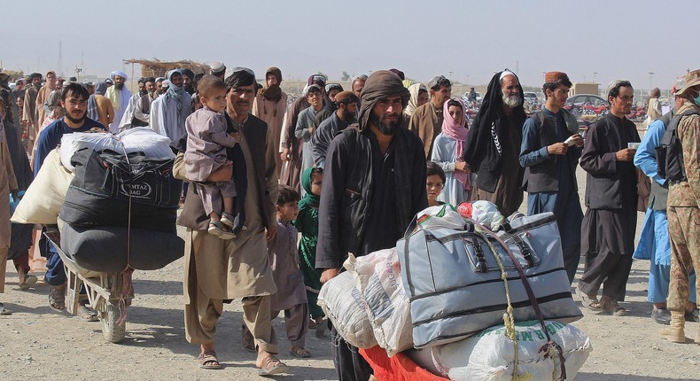 Afghan nationals arrive at the Pakistan-Afghanistan border crossing point in Chaman on August 20, 2021, to return back to Afghanistan
