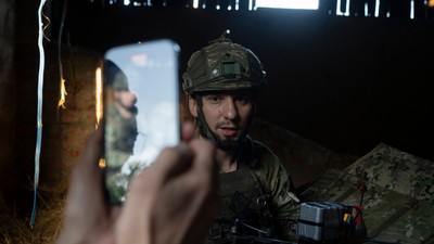 A Ukrainian soldier, nicknamed Stem, presents an attack drone he just loaded with shells for a social media post in the outskirts of Kremmina, Ukraine, Sunday, Aug. 20, 2023.AP Photo/Bram Janssen