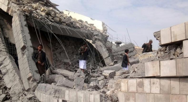 A Yemeni boy stands on the rubble of a school destroyed by a Saudi-led air strike on the outskirt of the northwestern Saada province