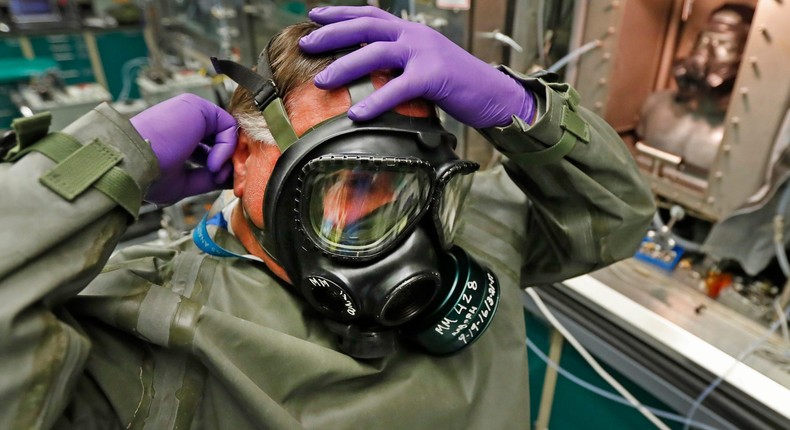 A technician puts on a gas mask as he prepares for a chemical test in Dugway Proving Ground in 2017.George Frey/Getty Images