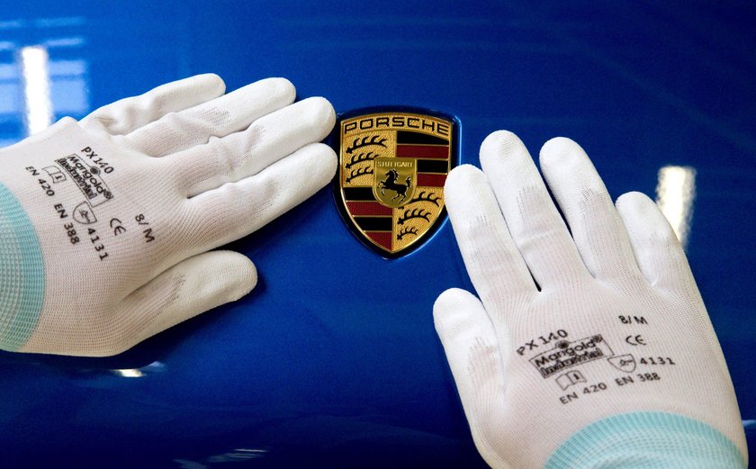 FILE PHOTO: An illuminated Porsche logo is pictured on a building of a Porsche retail centre in Nied