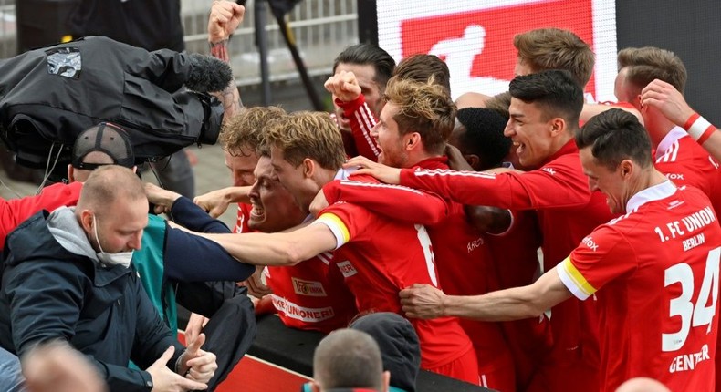 Union Berlin striker Max Kruse (C) is mobbed by team-mates after his winning goal Creator: John MACDOUGALL