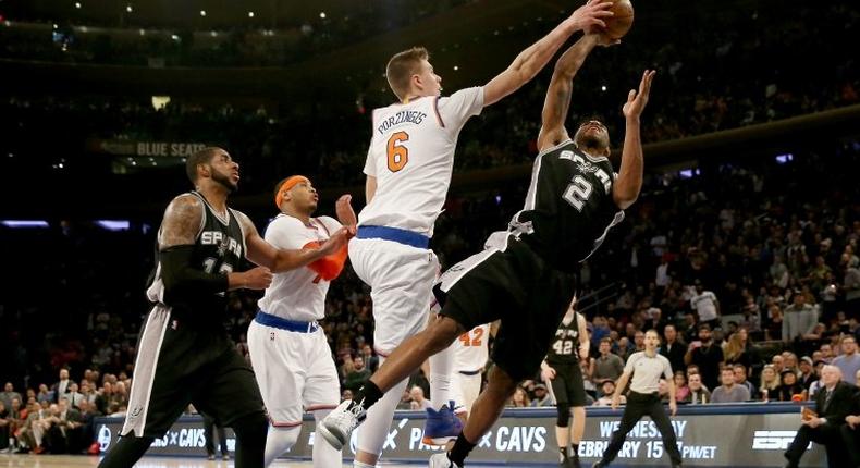 Kristaps Porzingis of the New York Knicks blocks a shot by Kawhi Leonard of the San Antonio Spurs in the fourth quarter, at Madison Square Garden in New York, on February 12, 2017