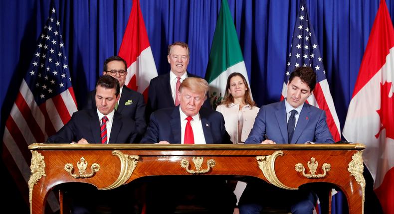 U.S. President Donald Trump, Canada's Prime Minister Justin Trudeau and Mexico's President Enrique Pena Nieto sign documents during the USMCA signing ceremony before the G20 leaders summit in Buenos Aires, Argentina November 30, 2018. REUTERS/Kevin Lamarque - RC15A3E02F60