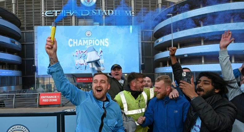 Manchester City fans celebrate winning the Premier League title