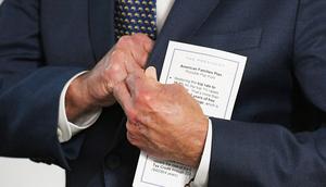 President Joe Biden holds a note card before delivering remarks. His use of cheat sheets has recently sparked some concerns from donors, according to a report.Mandel Ngan/AFP via Getty Image
