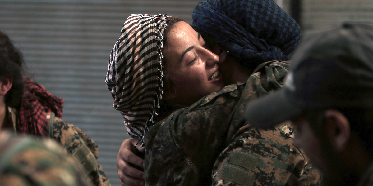 Syria Democratic Forces (SDF) female fighters embrace each other in the city of Manbij, in Aleppo Governorate, Syria, August 10, 2016.