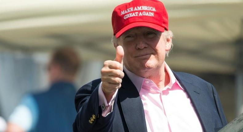 President Donald Trump salutes wellwishers at the US Women's Open Golf Championship at Trump National Golf Course in Bedminister, New Jersey