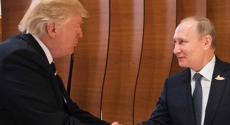 President Donald Trump shakes hands with Vladimir Putin, President of Russia (right), at the opening of the G20 summit on July 7, 2017 in Hamburg, Germany.