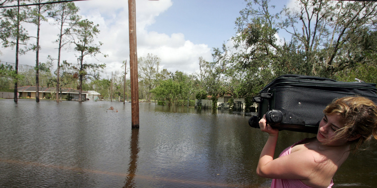A girl carries her belongings in Louisiana following the disastrous Hurricane Rita in 2005.
