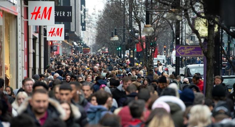 Scenes like this image of London shoppers taken on December 27, 2018 could become more common in countries where the population is booming - although overall global growth is slowing