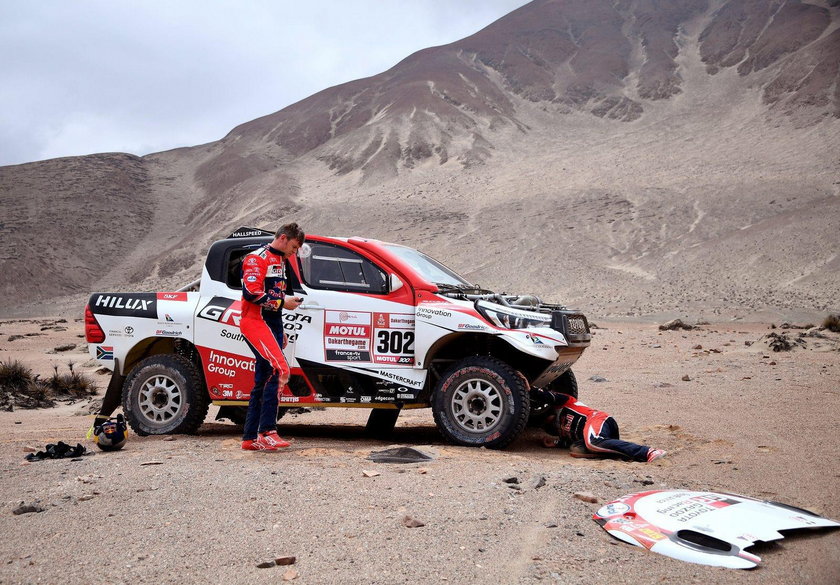 Driver Giniel De Villiers, of South Africa, and co-driver Dirk Von Zitzewitz, of Germany, work on th