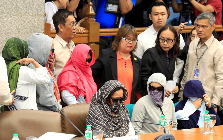 Relatives of slain people attend a Senate hearing investigating drug-related killings at the Senate headquarters in Manila