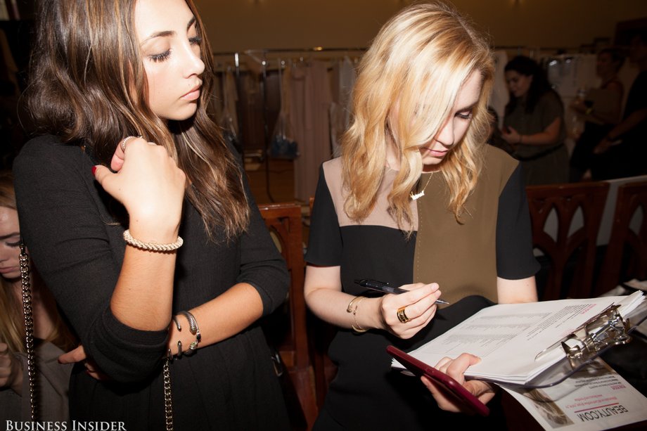 Oliva's direct supervisor, beauty account executive Victoria Natenzon, double-checks the RSVP list.