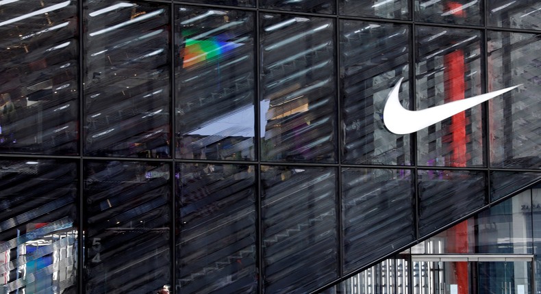 FILE PHOTO: People wearing protective face masks walk past the closed Nike store on a nearly empty 5th Avenue, during the outbreak of the coronavirus disease (COVID-19), in Manhattan, New York city, New York, U.S., May 11, 2020. REUTERS/Mike Segar