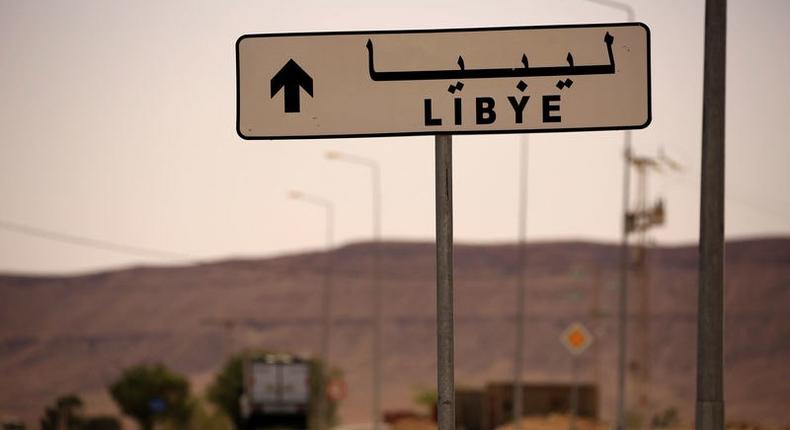 A road sign shows the direction of Libya near the border crossing at Dhiba, Tunisia April 11, 2016. 