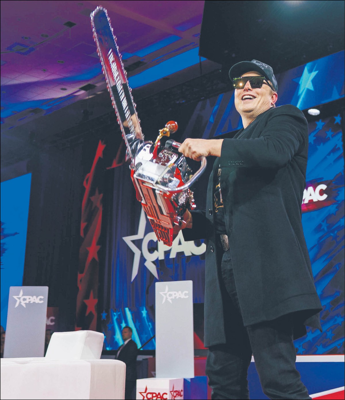 Elon Musk na konferencji CPAC z piłą elektryczną, którą otrzymał w prezencie od prezydenta Argentyny