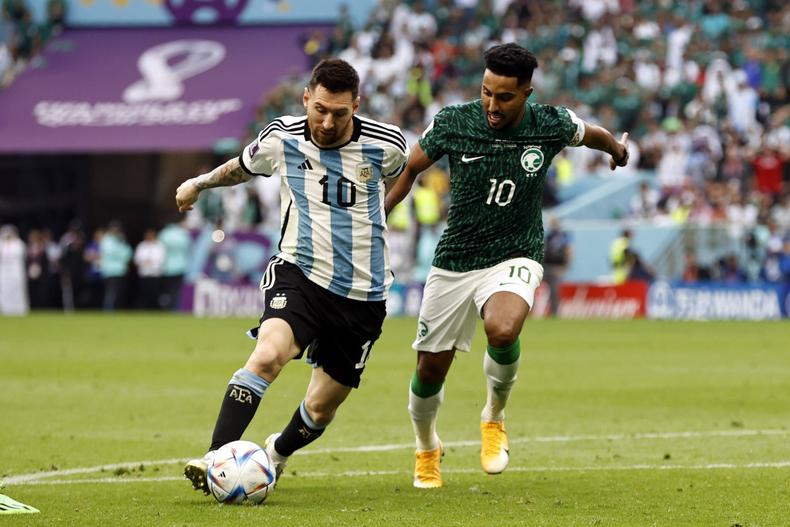 Lionel Messi of Argentina (left) and Salem Al-Dawsari (right) of Saudi Arabia during the FIFA World Cup on November 22, 2022.