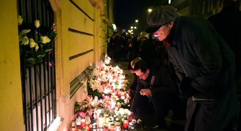 Mourners leave flowers and candles at a memorial in Budapest on January 22, 2017 for the victims of Friday's deadly coach crash in Italy