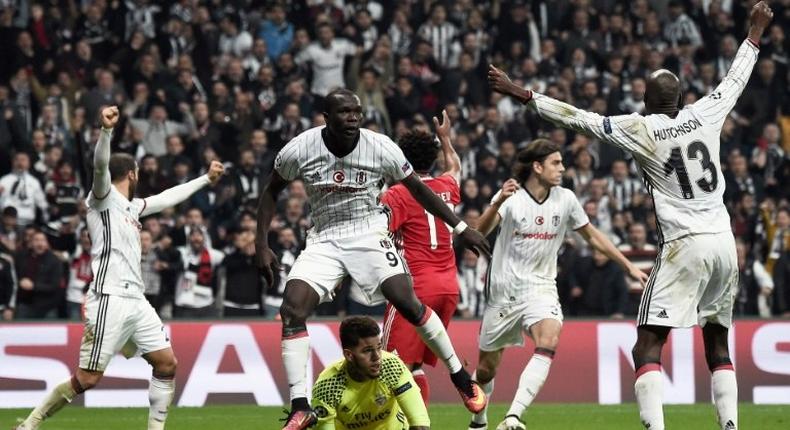 Besiktas' Vincent Aboubakar (C) celebrates after scoring against Benfica Lisbon at the Vodafone arena - both teams join Napoli in a race to stay in the Champions League