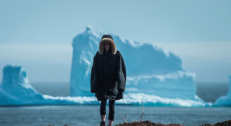 A resident near the first iceberg of the season as it passes the South Shore, also known as Iceberg Alley, near Ferryland, Newfoundland.