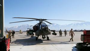 Maintenance workers towing out an Apache helicopter from a hanger in Kearns, Utah.George Frey/Getty Images