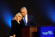 Israeli Prime Minister Benjamin Netanyahu hugs his wife Sara as they stand on stage following the an