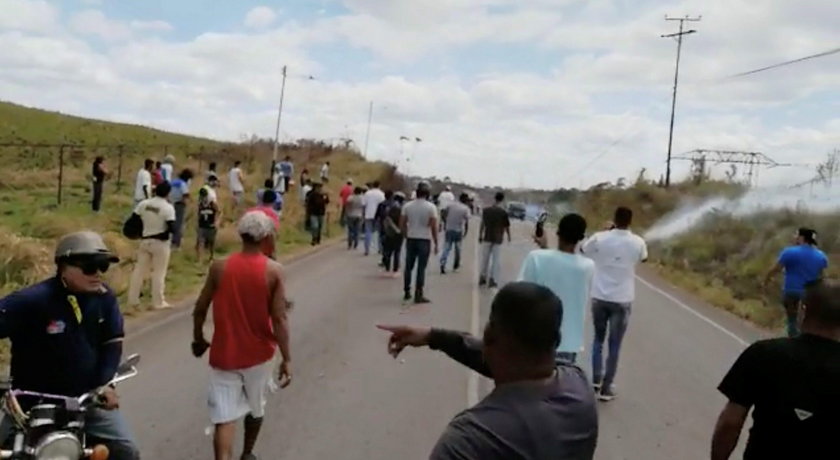 People look on as tear gas this thrown in Santa Elena De Uairen