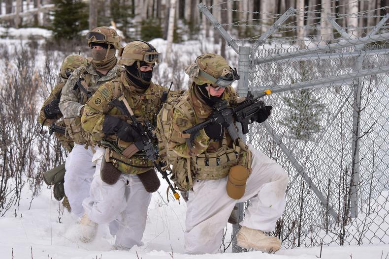 US Army paratroopers attack an objective at a training area in Alaska during Exercise Arctic Warrior, February 11, 2021.