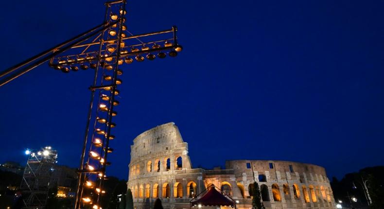 A cross lit with candles in front of the Coliseum in Rome ahead of the Way of the Cross procession