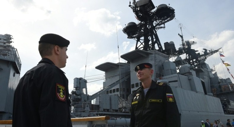 Russian Navy sailors stand guard at the gangway leading to the anti-submarine ship Admiral Tributs shortly after arriving at port in Manila on January 3, 2017