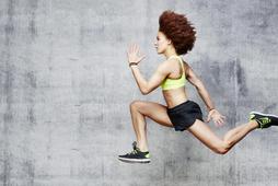 Woman jumping in air in urban studio