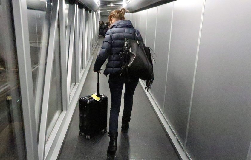 A cabin crew member serves passengers onboard a Ryanair passenger aircraft travelling from Madrid In