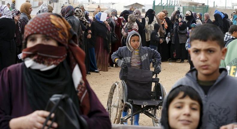 Syrian refugees stand in line as they wait for aid packages at Al Zaatari refugee camp in the Jordanian city of Mafraq, near the border with Syria, January 20, 2016. REUTERS/ Muhammad Hamed