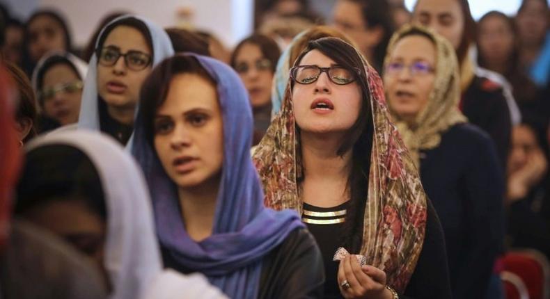 Egyptians pray during the Good Friday procession at the St. George church in Mahalla in northern Egypt on April 14, 2017