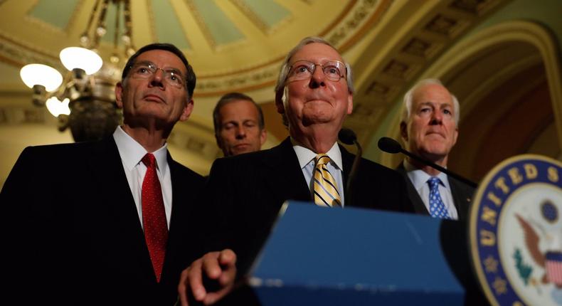 Senate Majority Leader Mitch McConnell, accompanied by Senator John Cornyn (R-TX) and Senator John Barrasso (R-WY), speaks with reporters following the successful vote to open debate on a health care bill on Capitol Hill.