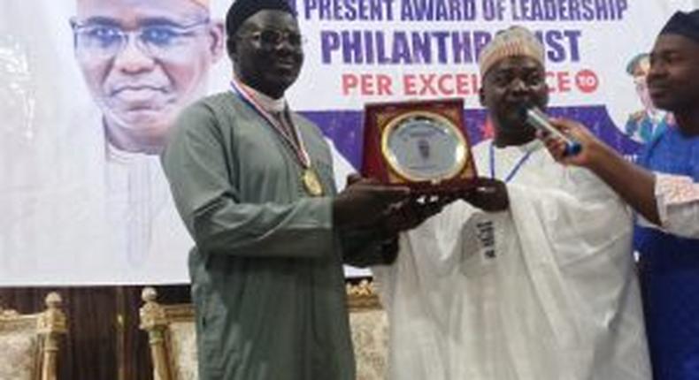 Former Chief of Army Staff, retired Lt.-Gen. Tukur Buratai receiving award of Philanthropy per Excellence form the President, Forum of Ex-Councilors, Mr Awwal Hassan on Thursday (24/11/22)