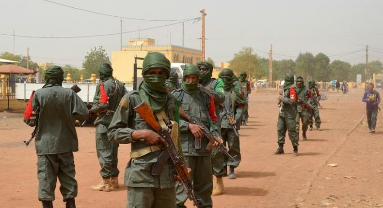 Malian army soldiers, pro-government militia members and former rebels, predominantly Tuaregs, take part in their first joint patrol in Gao in northern Mali on February 23, 2017