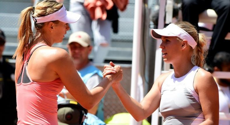 Maria Sharapova (L) shakes hands with Caroline Wozniacki after their Madrid Open match in 2015