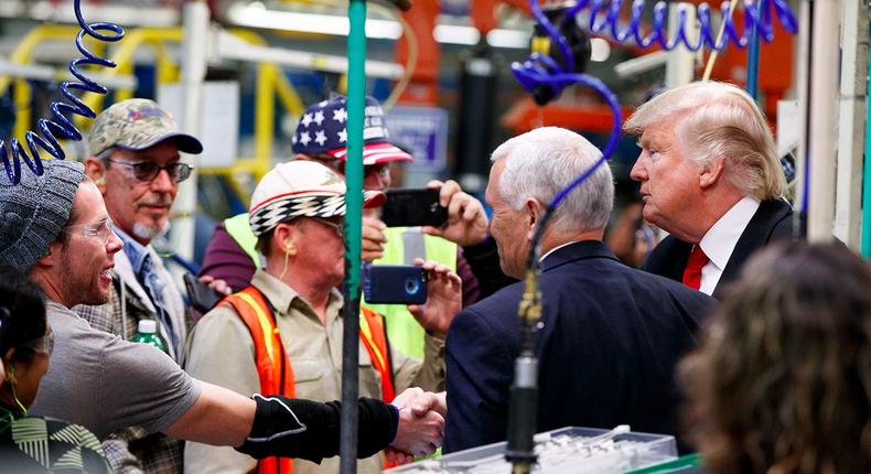 President-elect Donald Trump and Vice President-elect Mike Pence talk with factory workers during a visit to the Carrier factory, Thursday, Dec. 1, 2016, in Indianapolis, Ind.