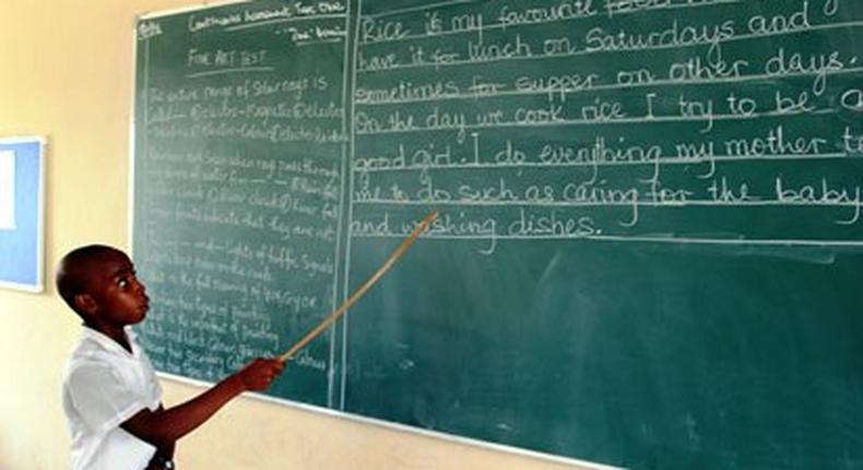 A pupil reading from the chalkboard