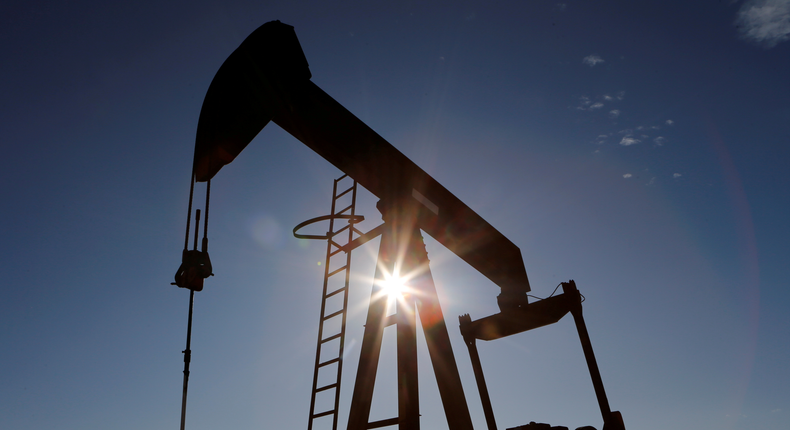 FILE PHOTO: The sun is seen behind a crude oil pump jack in the Permian Basin in Loving County, Texas, U.S., November 22, 2019. REUTERS/Angus Mordant