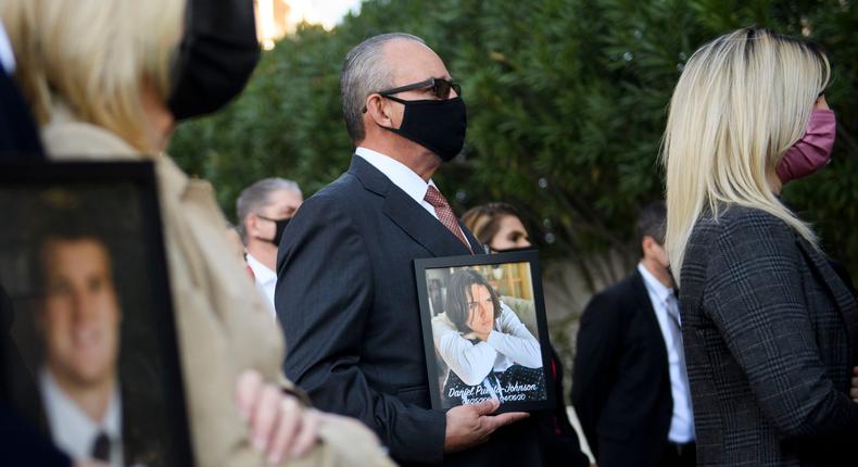 Jaime Puerta, center, holds a portrait of his son Daniel Puerta-Johnson, who died in April 2020 at the age of 16 from a pill containing fentanyl, in February in Los Angeles.
