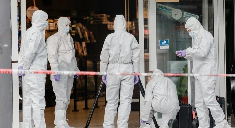 Police investigator work at the area around a supermarket in the northern German city of Hamburg, where a man killed one person in a knife attack, on July 28, 2017