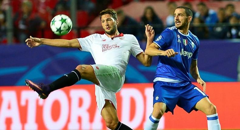 Sevilla's forward Franco Vazquez (L) clashes with Juventus' defender Leonardo Bonucci on November 22, 2016